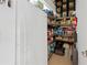 Pantry featuring an upright refrigerator and shelves stocked with supplies at 23075 Hayman Rd, Brooksville, FL 34602