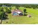 Backyard aerial view featuring a screened-in pool and patio area at 23075 Hayman Rd, Brooksville, FL 34602
