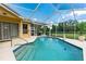 Backyard pool with screened enclosure and covered porch at 23075 Hayman Rd, Brooksville, FL 34602