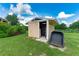 Outdoor shed with lawn equipment inside at 23075 Hayman Rd, Brooksville, FL 34602