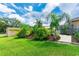 Landscaped yard with mature trees and plantings adds curb appeal to this property at 23075 Hayman Rd, Brooksville, FL 34602