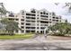 Elegant condo building featuring balconies, lush landscaping, and convenient parking at 2333 Feather Sound Drive # A409, Clearwater, FL 33762