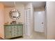 Hallway features decorative cabinet, mirror, closet and entry door at 2333 Feather Sound Drive # A409, Clearwater, FL 33762