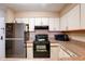 Functional kitchen featuring white cabinets, modern appliances, and ample counter space at 2333 Feather Sound Drive # A409, Clearwater, FL 33762