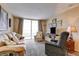 Bright living room featuring a sliding glass door and comfortable furnishings at 2333 Feather Sound Drive # A409, Clearwater, FL 33762