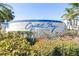 Crystal Bay at Feather Sound sign surrounded by greenery, and clear blue skies at 2333 Feather Sound Drive # A409, Clearwater, FL 33762
