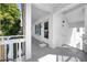 Condo balcony with white railings and an entry door to the unit at 2430 Florentine Way # 40, Clearwater, FL 33763