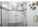 Updated bathroom features tiled shower, glass doors, handrails, and modern fixtures at 2430 Florentine Way # 40, Clearwater, FL 33763
