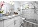 Bright, modern bathroom with granite counters, custom cabinets, and a glass-enclosed shower for a luxurious feel at 2430 Florentine Way # 40, Clearwater, FL 33763