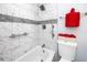 Bathroom with white tiled walls, shower and tub combo, and grab bars at 2430 Florentine Way # 40, Clearwater, FL 33763