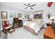 Comfortable bedroom featuring a ceiling fan, neutral colors, and a large window at 2430 Florentine Way # 40, Clearwater, FL 33763