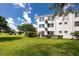 Bright building exterior with green lawn providing a serene and inviting curb appeal at 2430 Florentine Way # 40, Clearwater, FL 33763