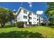 Well-maintained building exterior with lush green lawn, showcasing curb appeal and a welcoming environment at 2430 Florentine Way # 40, Clearwater, FL 33763