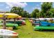 Array of colorful kayaks neatly stacked, set against a backdrop of green grass and trees at 2430 Florentine Way # 40, Clearwater, FL 33763