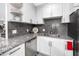 Updated kitchen with granite countertops, stainless steel appliances, and modern backsplash at 2430 Florentine Way # 40, Clearwater, FL 33763