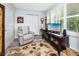 Comfortable living space with recliner, large window, and media center, perfect for relaxation at 2430 Florentine Way # 40, Clearwater, FL 33763