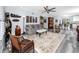 Inviting living room with gray sofa, decorative rug, and open layout to the bar and kitchen area at 2430 Florentine Way # 40, Clearwater, FL 33763