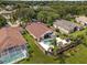 Aerial view of property showcasing the pool, outdoor living space, and landscaping at 2511 Groveway Dr, Valrico, FL 33596