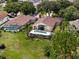 Aerial view of property highlighting the pool, patio, and mature landscaping at 2511 Groveway Dr, Valrico, FL 33596