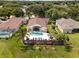 Aerial view of property highlighting the pool, outdoor living space, and mature landscaping at 2511 Groveway Dr, Valrico, FL 33596