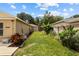 Side yard showcasing lawn and garden space, bordered by privacy fencing at 2511 Groveway Dr, Valrico, FL 33596