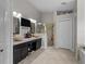 Elegant bathroom featuring double vanity, makeup counter, a glass enclosed shower and ceramic tile flooring at 2511 Groveway Dr, Valrico, FL 33596