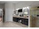 Primary bathroom with double vanity, walk in shower with ceramic tile, and vanity area with stool at 2511 Groveway Dr, Valrico, FL 33596