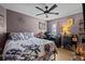 Bedroom featuring hardwood floors, light purple walls, a workstation, and a ceiling fan at 2511 Groveway Dr, Valrico, FL 33596