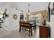 Charming dining area features bench seating, decorative chandelier, and view into kitchen at 2511 Groveway Dr, Valrico, FL 33596