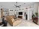 Cozy living room with tile floors, a ceiling fan, and a stylish sectional sofa, ideal for comfortable living and gatherings at 2511 Groveway Dr, Valrico, FL 33596