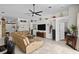 Spacious living room featuring tile floors, a ceiling fan, and a cozy fireplace, perfect for relaxation and entertaining at 2511 Groveway Dr, Valrico, FL 33596