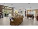 Bright and open living area with tile flooring, a comfortable sectional sofa, and easy access to the dining and outdoor spaces at 2511 Groveway Dr, Valrico, FL 33596