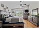 Well lit primary bedroom boasts vaulted ceilings, wood floors and neutral tones at 2511 Groveway Dr, Valrico, FL 33596