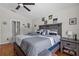 Comfortable main bedroom features wood floors, neutral colors, ceiling fan, and dresser at 2511 Groveway Dr, Valrico, FL 33596