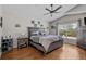 Comfortable main bedroom features wood floors, neutral colors, fan, and natural light at 2511 Groveway Dr, Valrico, FL 33596