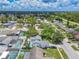Aerial view of a neighborhood featuring lush landscaping, homes and swimming pools at 2533 Blossom Lake Dr, Holiday, FL 34691