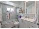 This bathroom features a vanity, a bathtub with shower and tiled walls at 2533 Blossom Lake Dr, Holiday, FL 34691
