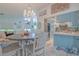 Charming dining area with chandelier, wood table, and blue accents creating a cozy and inviting space at 2533 Blossom Lake Dr, Holiday, FL 34691
