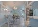 Cozy dining area with light wood floors and adjacent kitchen featuring stainless steel refrigerator at 2533 Blossom Lake Dr, Holiday, FL 34691