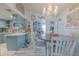 Cozy dining area featuring a chandelier, light wood floors, and adjacent kitchen access at 2533 Blossom Lake Dr, Holiday, FL 34691
