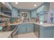 Well-lit kitchen boasting updated appliances, beautiful countertops, and ample cabinet space for storage at 2533 Blossom Lake Dr, Holiday, FL 34691