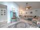 Inviting living room showcasing light wood floors, comfortable seating, and charming coastal decor at 2533 Blossom Lake Dr, Holiday, FL 34691