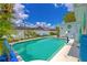 Backyard pool with white fence, palm trees and seating area for outdoor entertaining at 2533 Blossom Lake Dr, Holiday, FL 34691