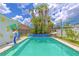 Private pool surrounded by tropical plants, with seating and lounging creating an ideal outdoor oasis at 2533 Blossom Lake Dr, Holiday, FL 34691