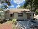 Rear view of a single-story home featuring a brown door and windows with awnings at 2800 13Th N Ave, St Petersburg, FL 33713