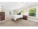 Bright bedroom featuring multiple windows, ceiling fan, and neutral carpeting at 304 21St N Ave, St Petersburg, FL 33704