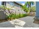 Driveway with a wooden fence and green foliage at 304 21St N Ave, St Petersburg, FL 33704