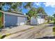Charming home featuring a detached garage, white fencing, and a quaint second-story porch at 304 21St N Ave, St Petersburg, FL 33704