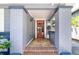 Inviting front porch showcasing brick columns, a red front door, and tile flooring, enhancing curb appeal at 304 21St N Ave, St Petersburg, FL 33704