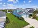 Aerial view of a blue two-story home with a well-manicured lawn at 3326 Woodmont Dr, Parrish, FL 34219